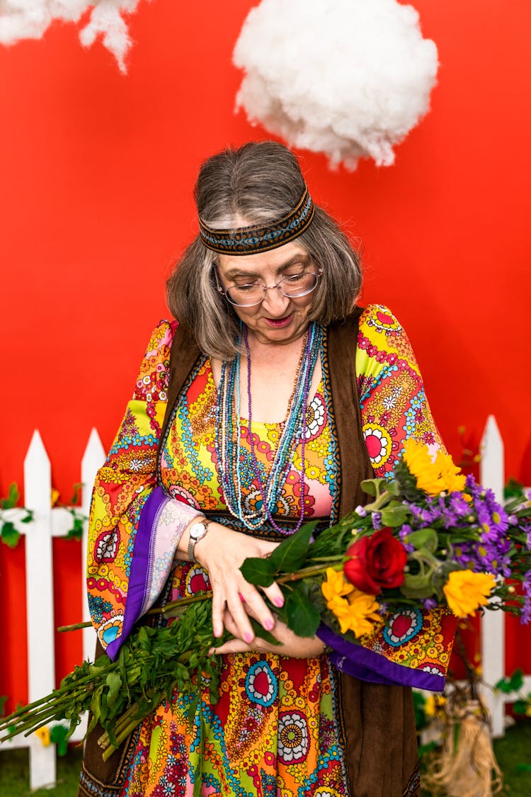 Woman In A Groovy Style Holding A Bunch Of Flowers