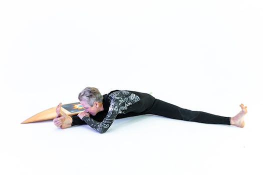 A senior woman in activewear stretches indoors with a surfboard, showcasing fitness and vitality.