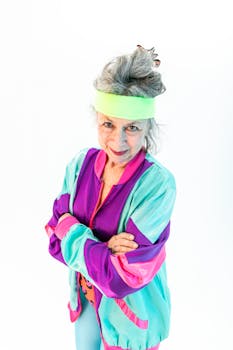 Joyful senior woman in colorful workout gear, embracing healthy living.