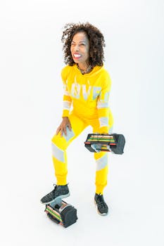 Energetic senior woman lifting weights in bright yellow activewear, promoting healthy living.