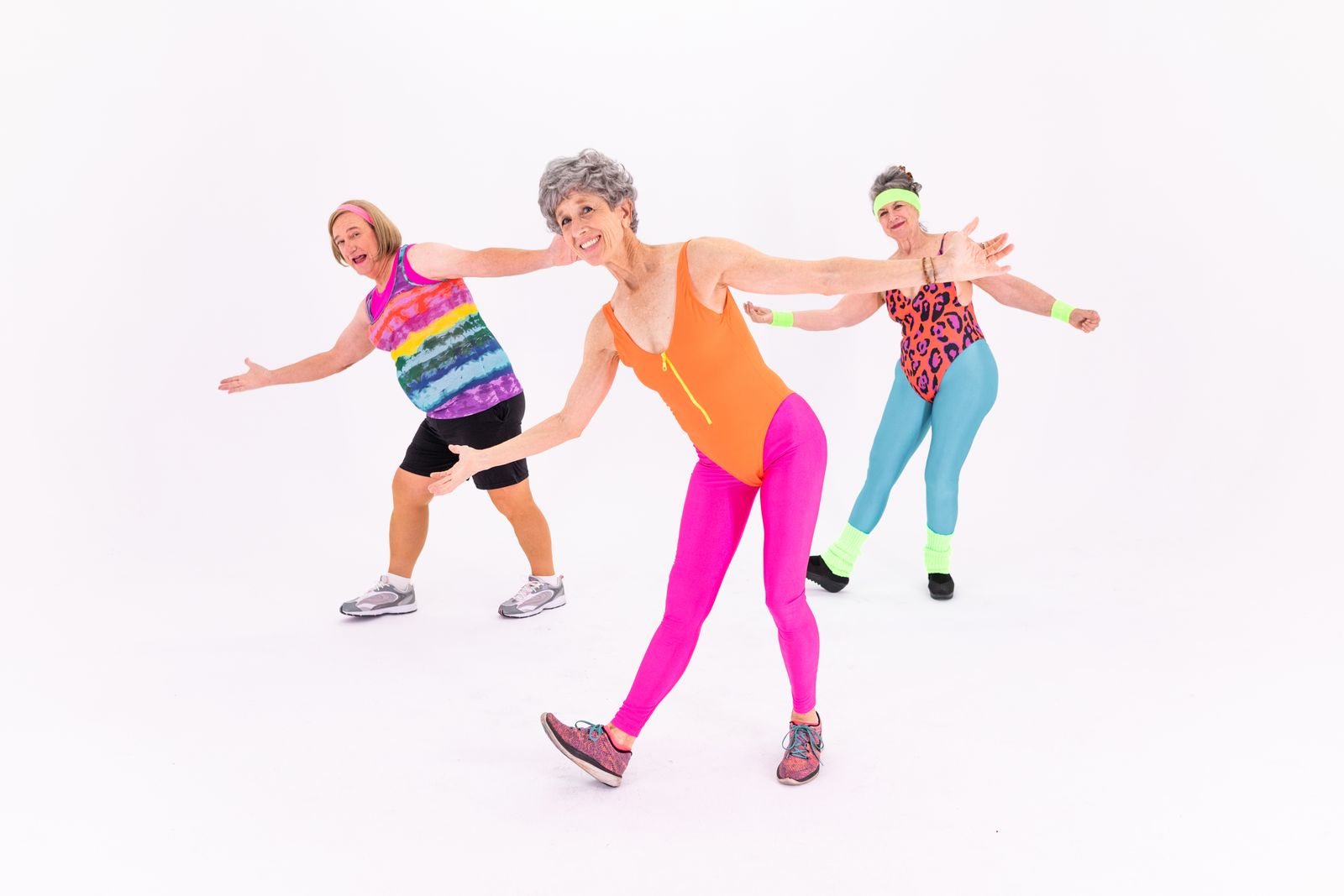 Energetic woman dancing with arms raised, radiating vitality and enthusiasm
