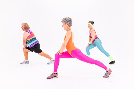 Senior women in colorful activewear enjoying a lively exercise session indoors, emphasizing fitness and joy.