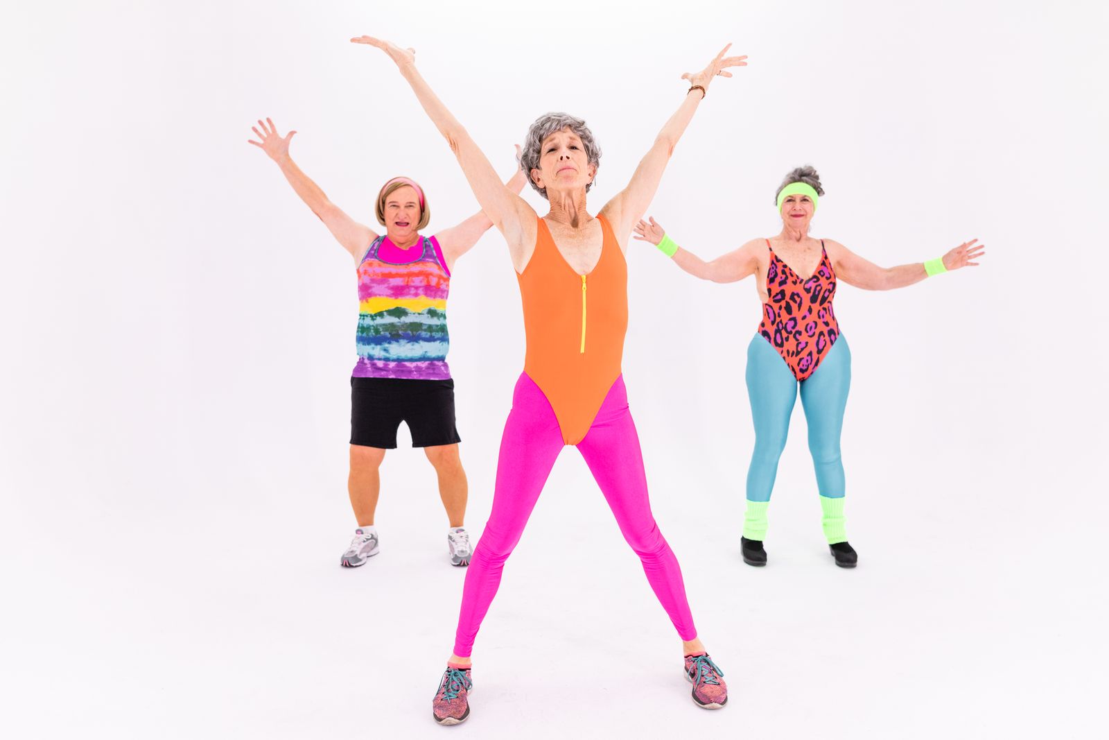Group of dancers smiling with high energy during an upbeat fitness class