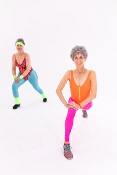 Two senior women in vibrant activewear performing fitness exercises with lively energy.