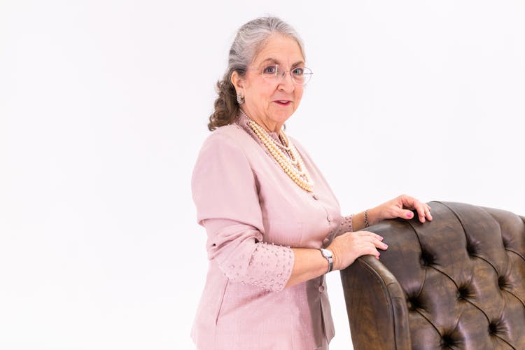 Woman Standing Near A Leather Chair