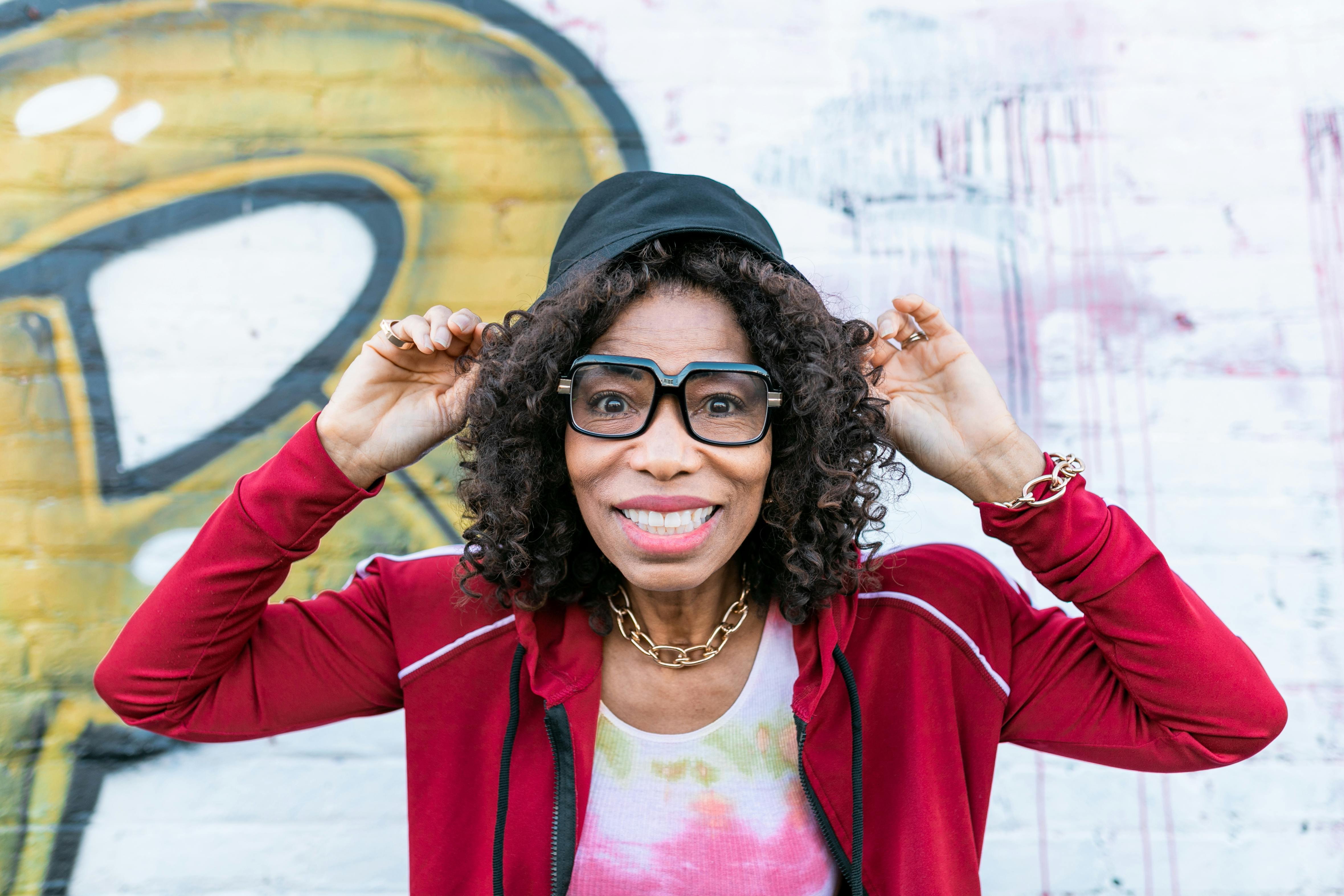 woman in red cardigan wearing black framed eyeglasses