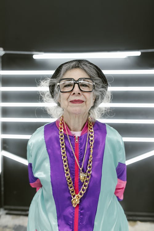 Free Elderly Woman Wearing Colorful Outfit With Flashy Jewelry Stock Photo