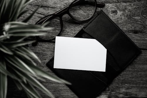 Free White Paper on Black Leather Wallet Stock Photo