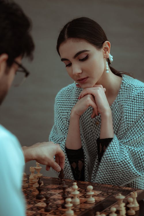 Thoughtful players making moves during chess game