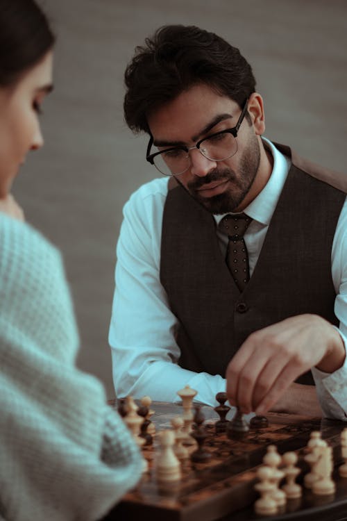 Concentrated people playing chess during tournament