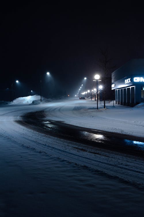 Photo of a Road Between Street Lights During Winter