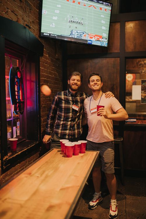 Free Two men playing beer pong at a Denver bar, enjoying nightlife and fun. Stock Photo