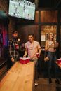 Man in Red and Black Plaid Dress Shirt Standing Beside Woman in Beige Long Sleeve Shirt