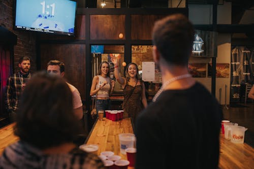 People Playing Beer Pong