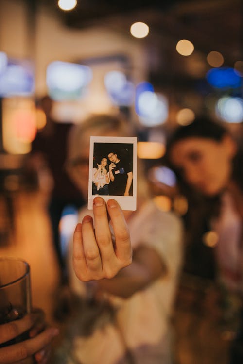 Free Photo of a Person's Hand Holding a Polaroid Picture Stock Photo