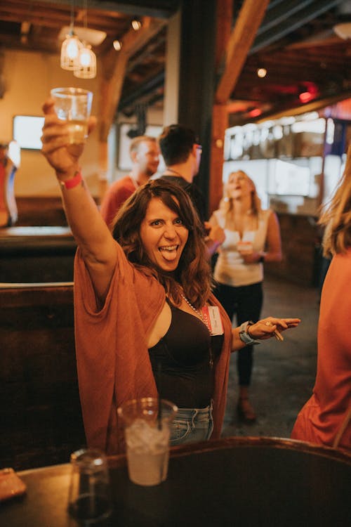 Photograph of a Woman Raising Her Drink