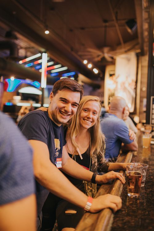 Free Happy couple relaxing at a Denver bar, capturing a fun night out. Stock Photo