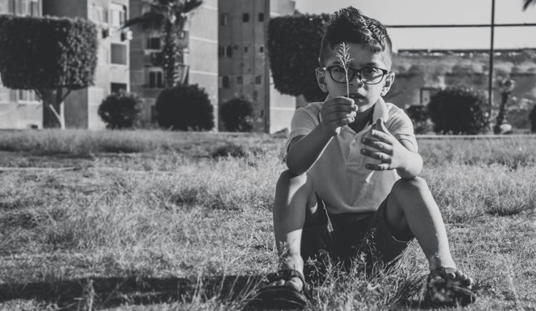 Greyscale Photo Of Boy Wearing Eyeglasses