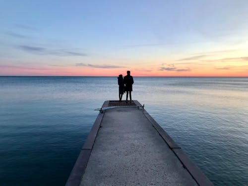 Couple Standing on a Concrete Dock