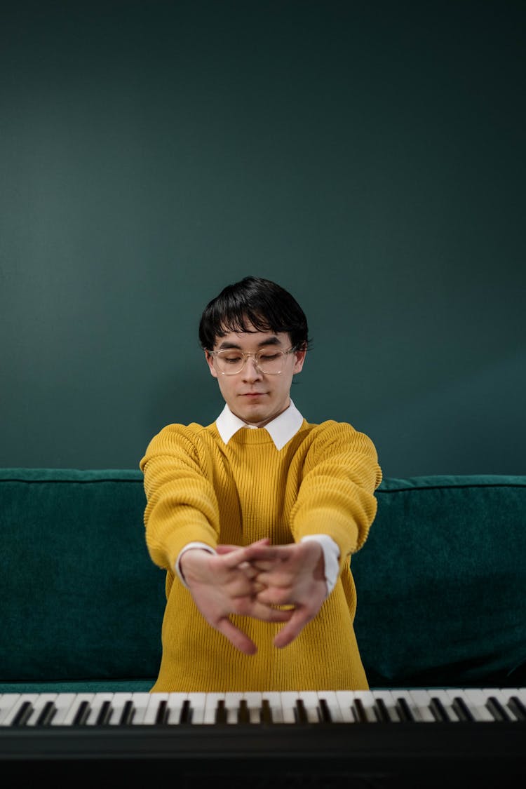 Man In Yellow Sweater Holding His Hands