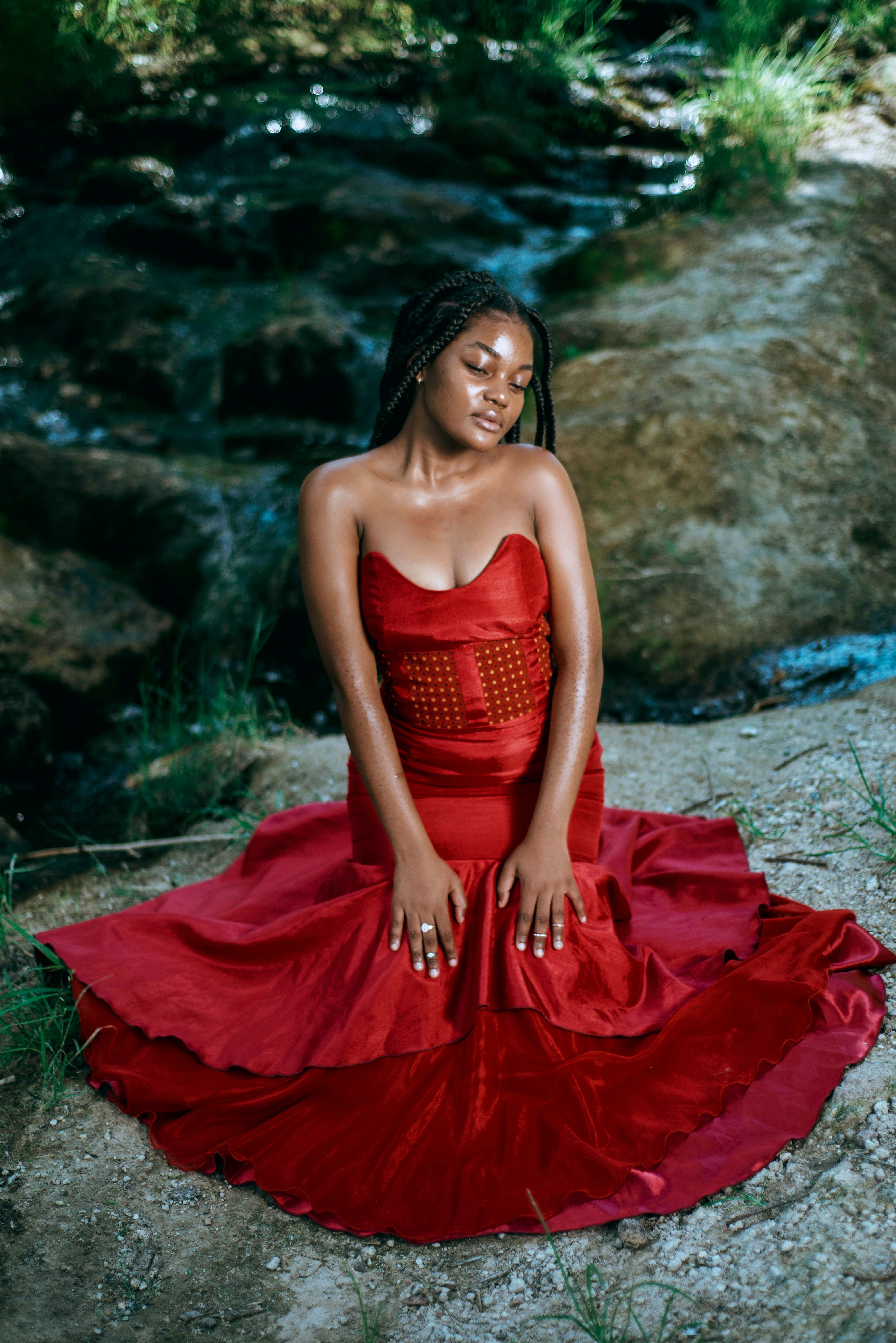 Photo of a Beautiful Woman in a Red Dress with Her Hands on Her Lap ...