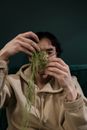 Man Holding Green Thread