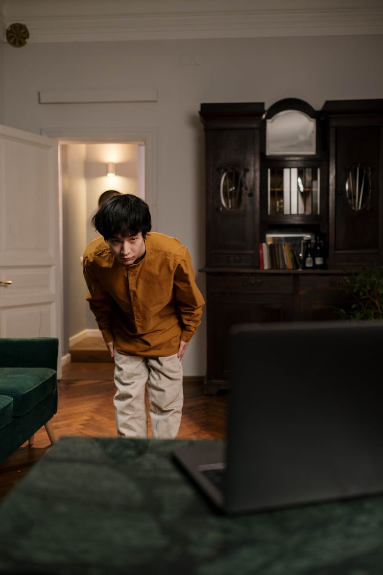 Photo Of A Man In A Mustard Shirt Bowing