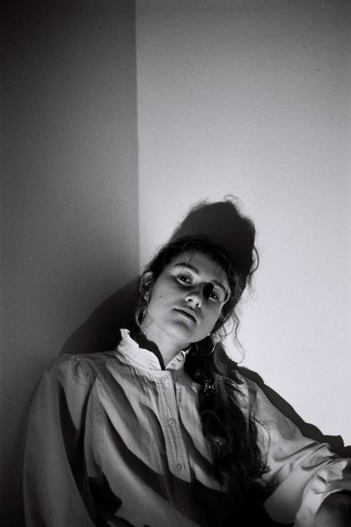 Free Artistic black and white portrait of a woman with dramatic shadows, captured indoors. Stock Photo