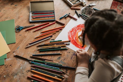 Photo of a Girl Drawing a Rainbow