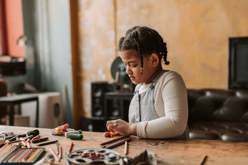 Photo of a Girl Playing with Clay