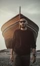 Man in Brown Crew Neck Long Sleeve Shirt Wearing Black Sunglasses