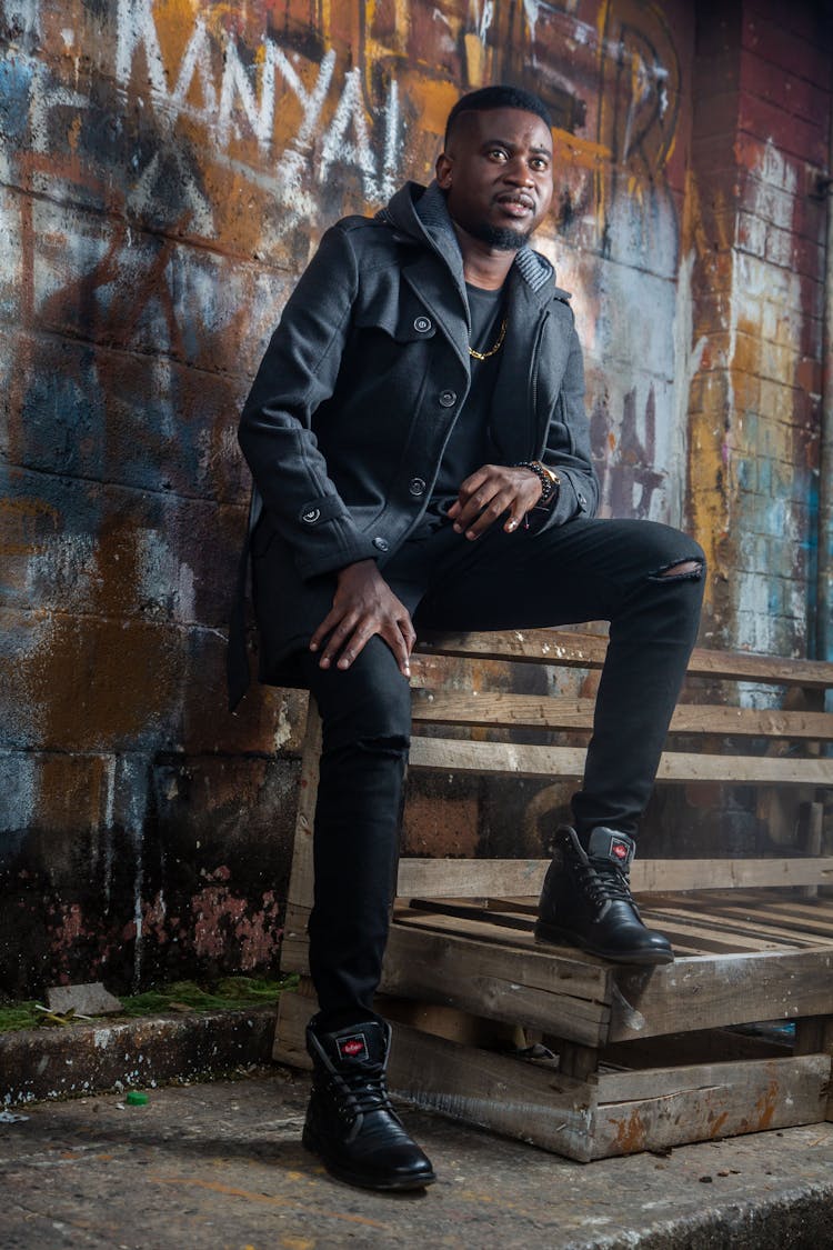 Man In Black Jacket Sitting On Wooden Bench