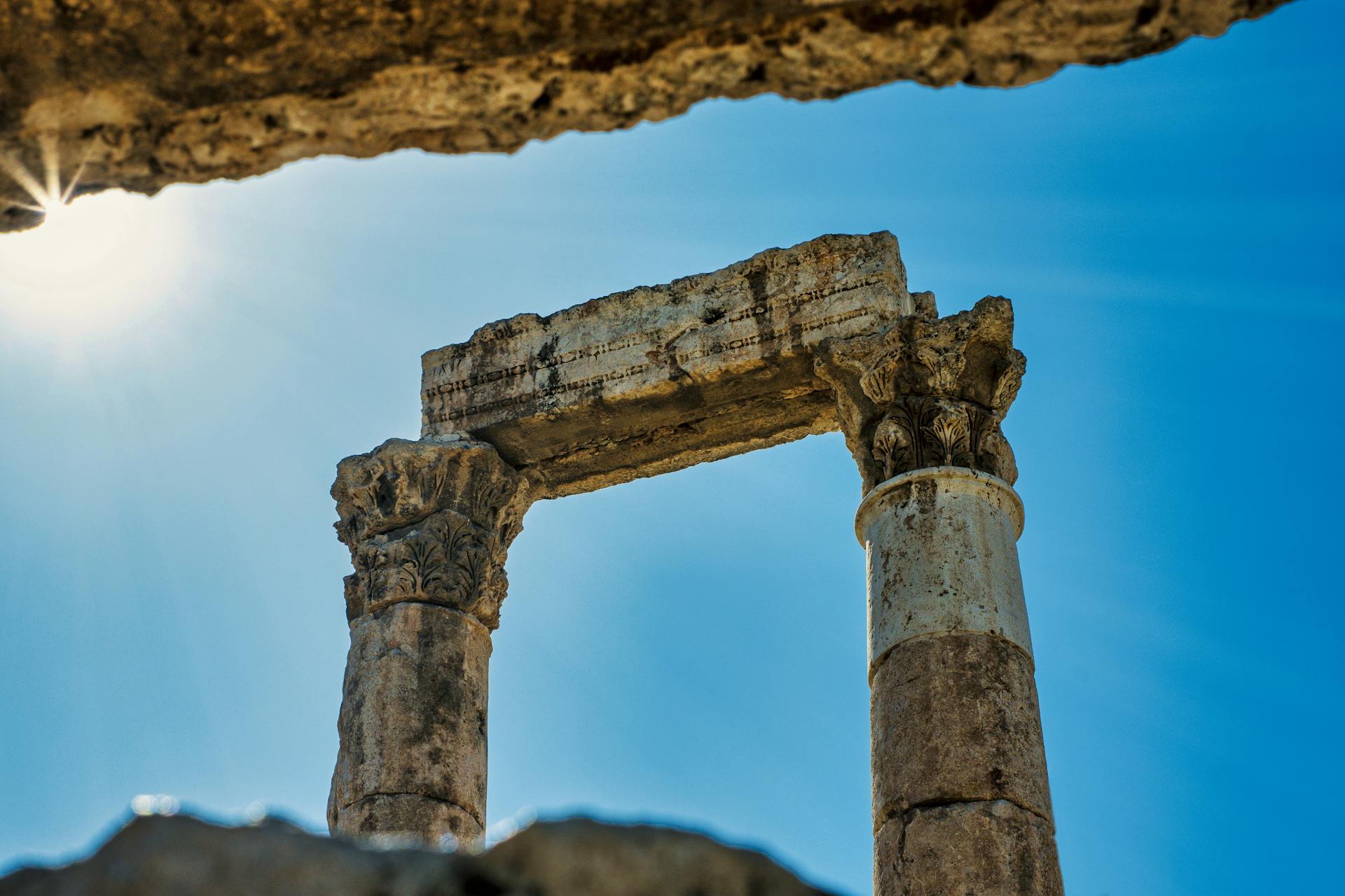 Ancient Roman columns at the Citadel in Amman, Jordan under a blue sky.