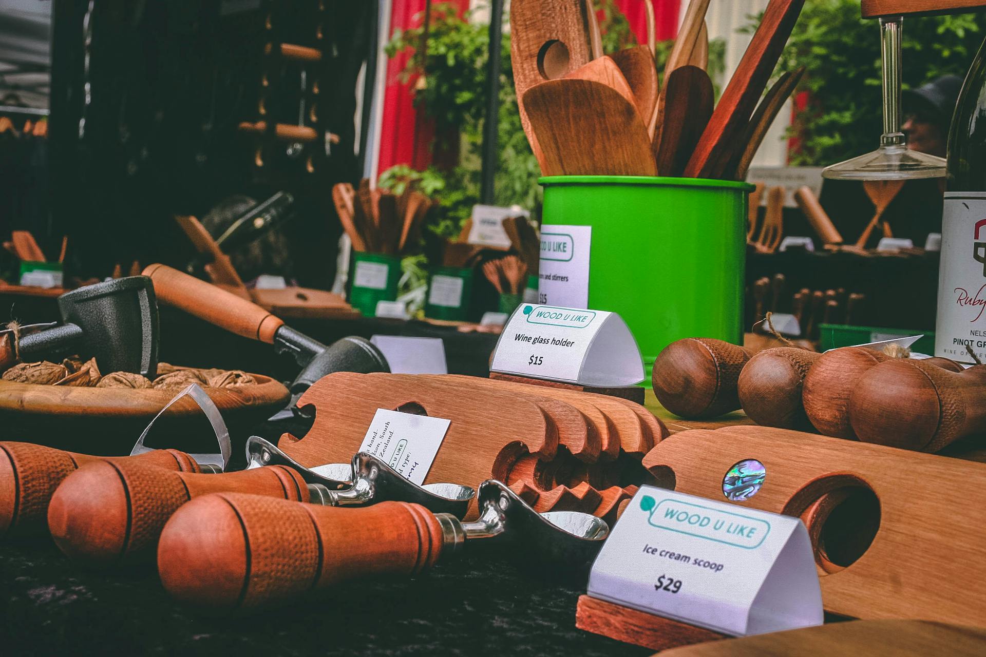 Beautiful display of handcrafted wooden kitchen utensils at an outdoor market stall.