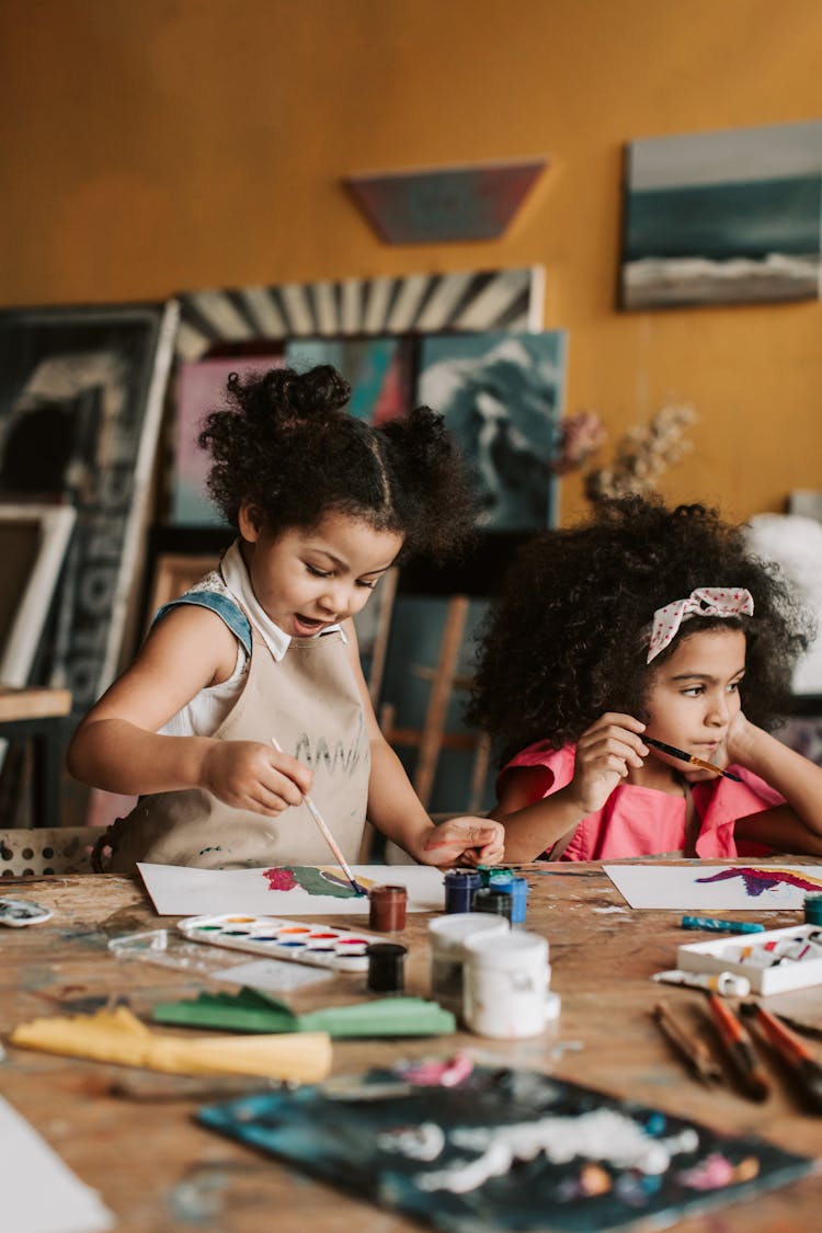 Girls Doing Painting On Brown Wooden Table