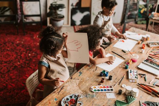 Group of children enjoying a creative painting session at an art workshop.