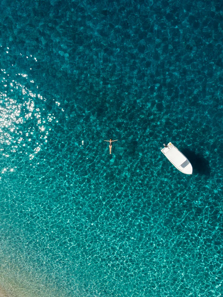 Drone Shot Of A Woman Floating On The Sea