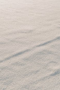 A detailed surface view of untouched snow, displaying a serene winter landscape.