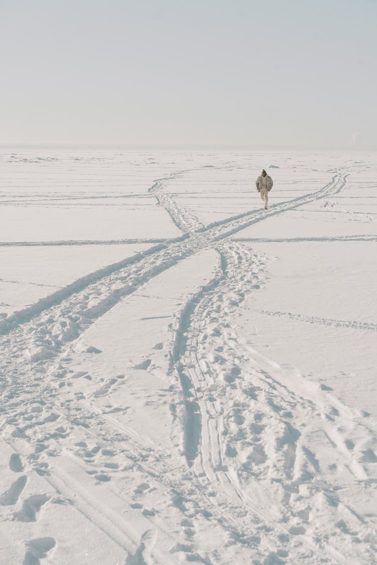 A Person Running In The Snow Covered Road