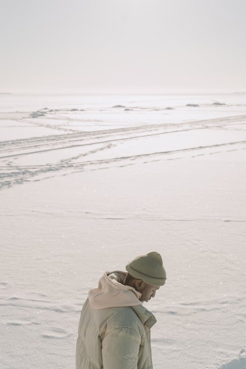 Photo of a Man Wearing a Puffer Jacket and a Beanie