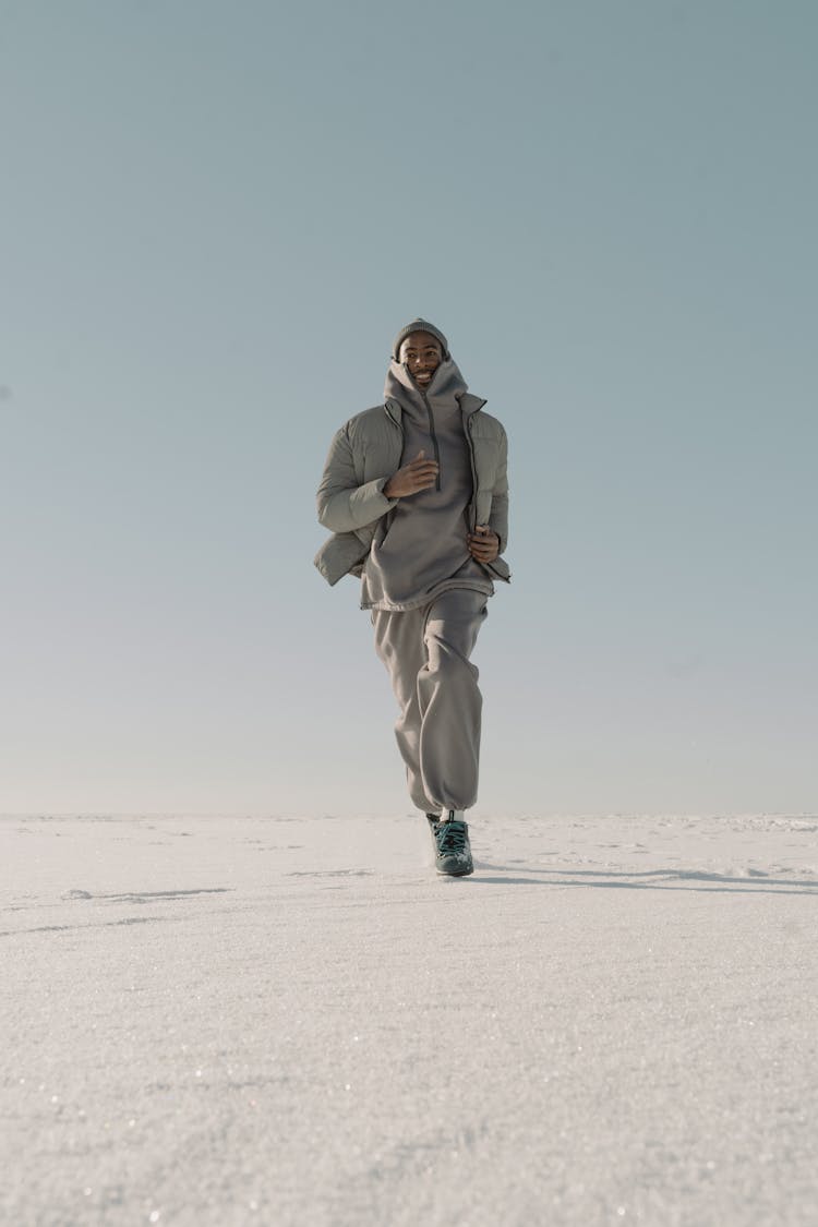 Man In Gray Jacket Running On Snow