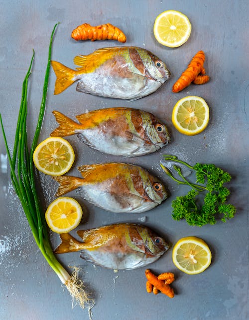 Yellow and Silver Fish on Gray Surface