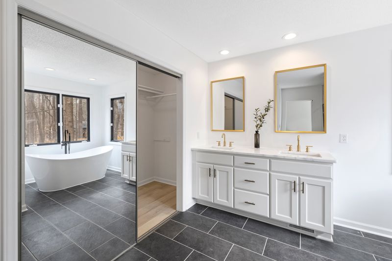 Elegant primary bathroom with double vanity and soaking tub