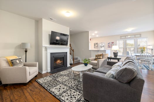 Spacious living room featuring a fireplace, TV, and comfortable seating arrangement.