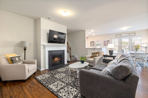 Free Spacious living room featuring a fireplace, TV, and comfortable seating arrangement. Stock Photo