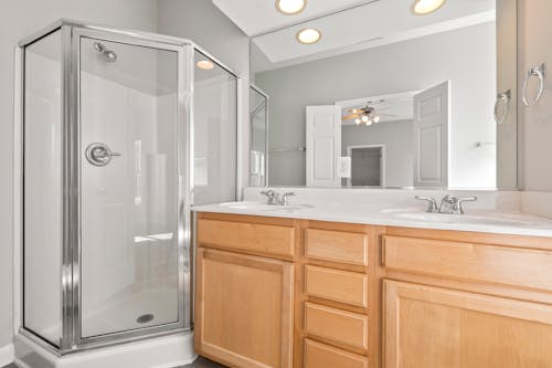 Free Bathroom with Glass Wall Shower Area and Mirror Stock Photo