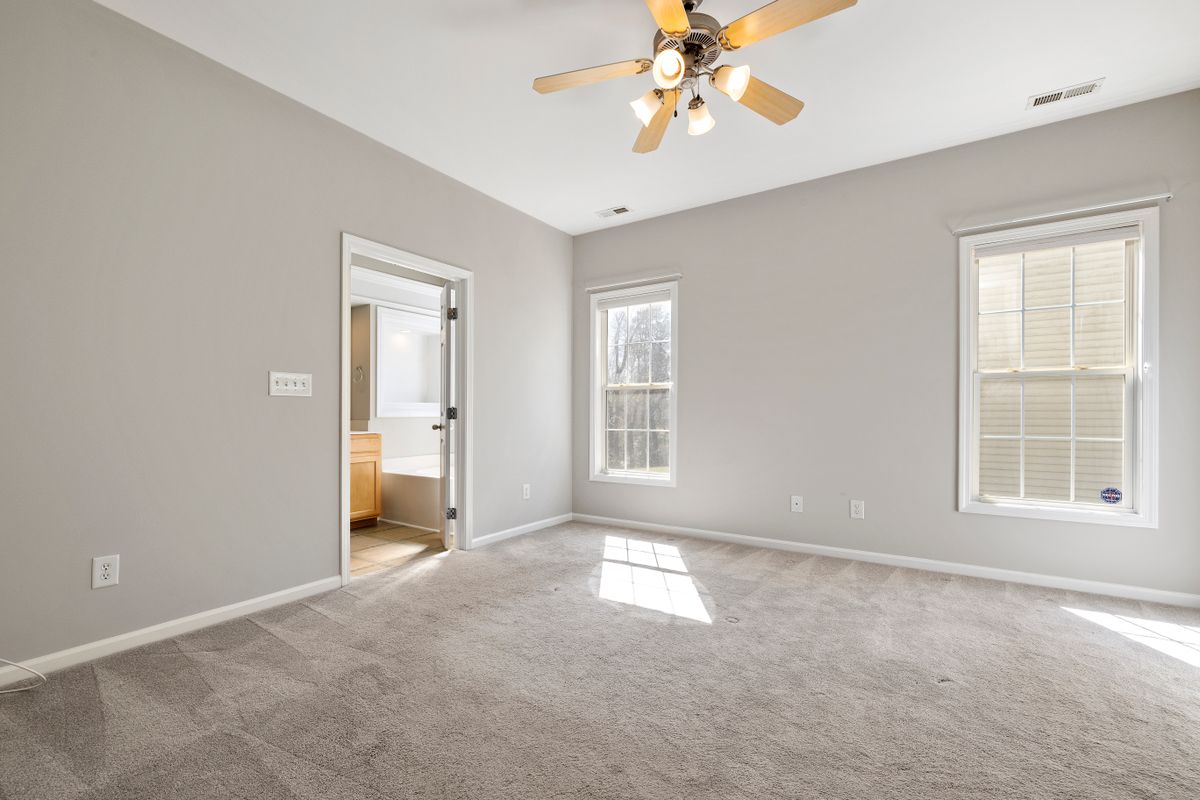 Clean bright room with a ceiling fan