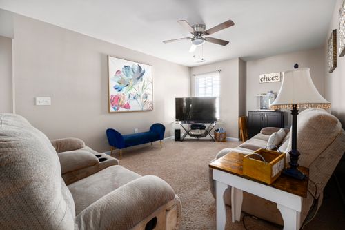 Free A modern living room featuring comfortable recliners, stylish decor, and a large TV for entertainment. Stock Photo