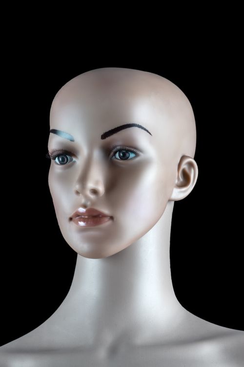 Free Close-up shot of a realistic female mannequin head against a dark background. Stock Photo