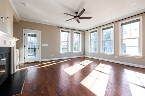 An Empty Living Room with Hardwood Flooring 